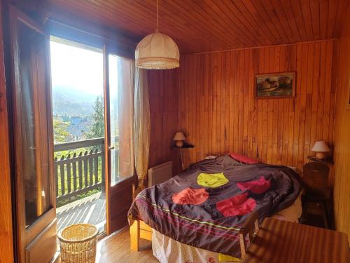 a bedroom with a bed and a large window at Chalet Samoëns, 5 pièces, 8 personnes - FR-1-629-103 in Samoëns