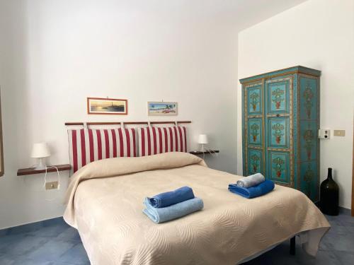 מיטה או מיטות בחדר ב-Rosa Dei Venti Marettimo