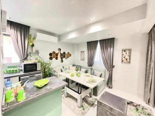 Luxury Studio House 589-3 في السادس من أكتوبر: مطبخ وغرفة معيشة مع طاولة وكراسي