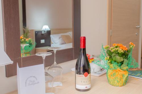 a bottle of wine sitting on a table in a room at Porta delle Botteghelle in Trapani