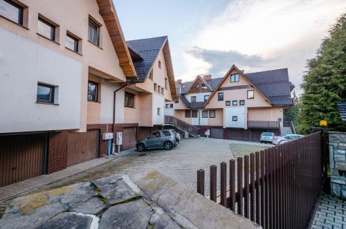 a car parked in a parking lot next to some houses at Giewont Mountain View Apartment in Zakopane