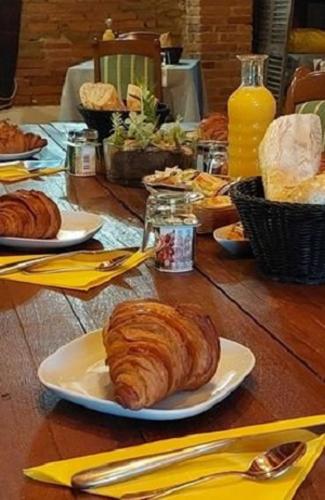a table topped with plates of pastries on top at L'ALCOVE HOTEL RESTAURANT in Villematier