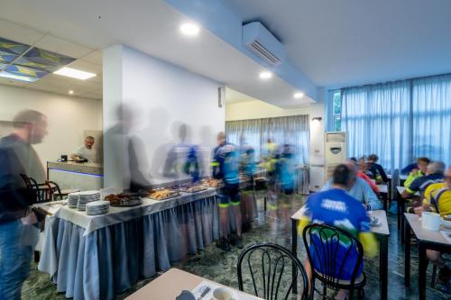 a group of people sitting at tables in a room at Real Park Hotel in Cavi di Lavagna