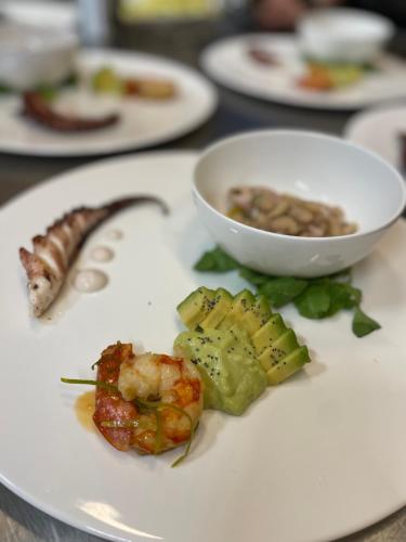 a white plate with food on a table at Burlamacchi Villas in Bagni di Lucca