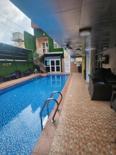 a swimming pool with a chair in a building at Atlantic Palms Suites in Lekki