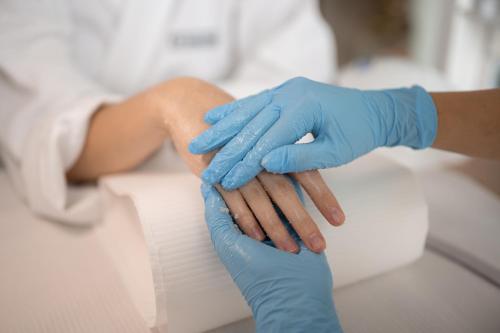a person in blue gloves holding a patient at Crystal Mountain Hotel Wisła in Wisła