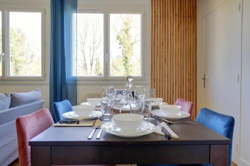 - une table à manger avec des verres et des assiettes dans l'établissement - L'Intemporel - Parking - Centre - WIFI, à Albi