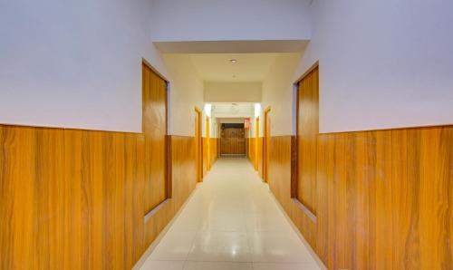 a hallway with wood paneling and a long corridor at Itsy Hotels Satya Shree in Katra