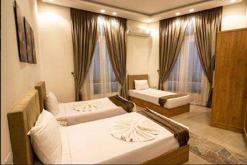 a hotel room with two beds and a couch at NEW CITY VIEW in Cairo