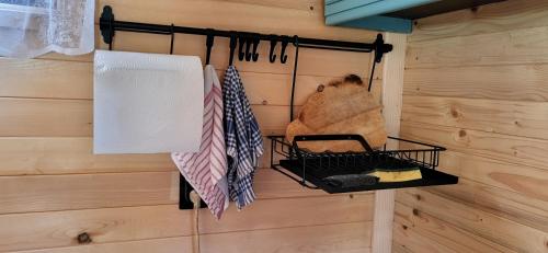 a room with a wall with a rack with umbrellas at Brvnara Lepota življenja in Dragolj