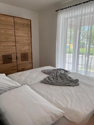 a bed with a blanket on it with a window at Graz, Citytrip, Städtereise, Style-Apartment Loft 35 in Graz