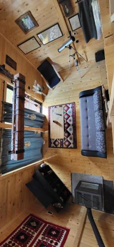 a room with a wooden wall with rugs and windows at Brvnara Lepota življenja in Dragolj