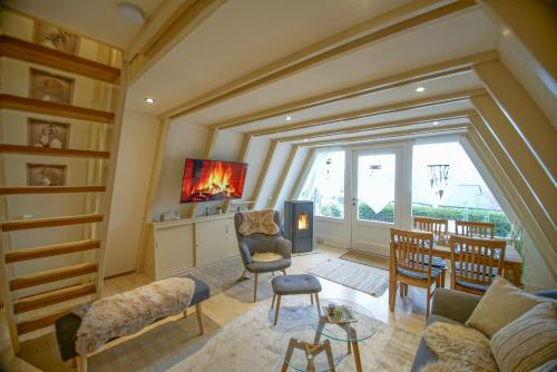 a living room with a fireplace and a couch and chairs at Ferienhaus Nordic Harmony in Waldkirchen