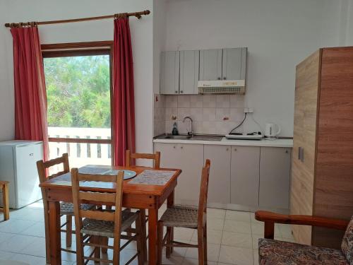 a kitchen with a table and chairs and a dining room at Livadia Studios in Ropanianá