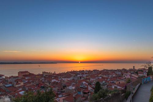 a view of a city at sunset at Studio Carmen in Piran