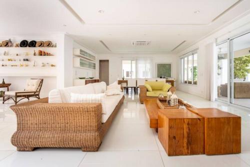 a living room with a couch and a coffee table at Suites Guarujá Pernambuco in Guarujá