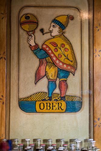 a picture of a painting of a person holding a pizza at 3 Sterne Boutique Gasthaus Pöstli in Rifferswil