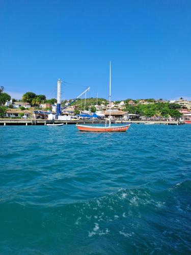 a boat in the middle of a large body of water at La Coloniale in Búzios