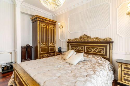 a bedroom with a large bed and a chandelier at B&Boutique Lamezia Terme in Lamezia Terme