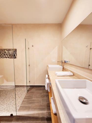a bathroom with a sink and a shower at Sofía Boutique Condos by Bunik in Playa del Carmen