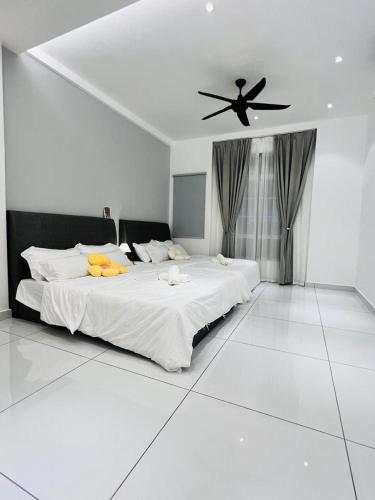 - une chambre avec un grand lit et un ventilateur de plafond dans l'établissement Inn Homestay 1st Floor Unit, à Teluk Intan