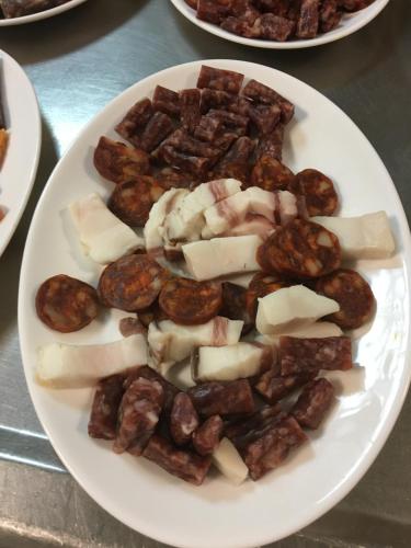 a plate of food with cheese and meats on a table at Hotel Mesón del Moro in Abarán