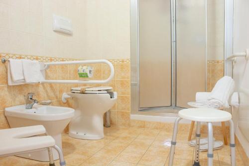 a bathroom with a shower and a toilet and a sink at Porta delle Botteghelle in Trapani