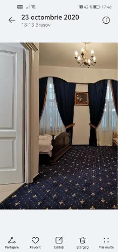 a hotel room with a bed and a chandelier at Weiss Little Palace in Braşov