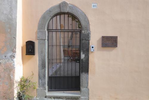 una puerta en el lateral de un edificio con una señal en Casa Vacanze Le Volte Tuscania, en Tuscania