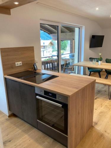 a kitchen with a stove and a counter top at Schöne Aussicht in Riezlern