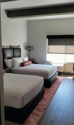 a hotel room with two beds and a window at Bunk House in Madras