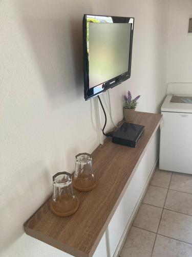 a tv sitting on top of a wooden shelf at Karampinis in Kali Limenes