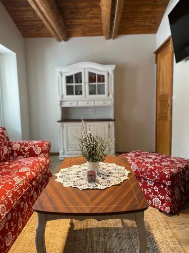 a living room with a coffee table and a fireplace at Emakaru Puhkemaja in Otepää