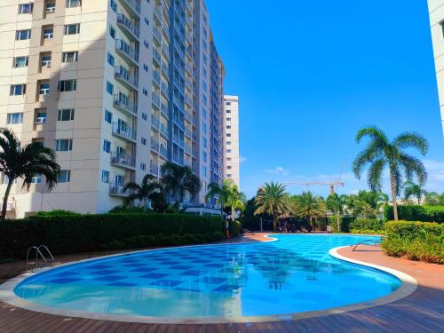 a large swimming pool in front of a building at South residence in Manila