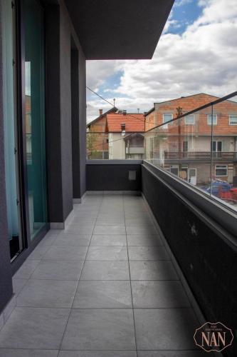an empty balcony with a view of a building at Apartmani NAN in Visoko