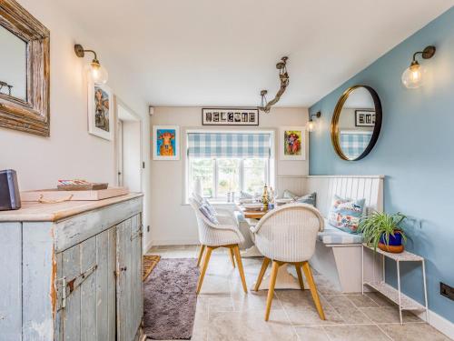 una cucina con pareti blu e tavolo e sedie di Pass the Keys Beautiful Cottage In South Downs a Chichester