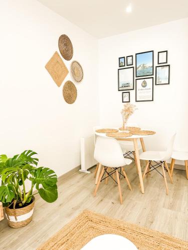 a dining room with a table and chairs at A Lobeira Grande by ALÔGA in Cee