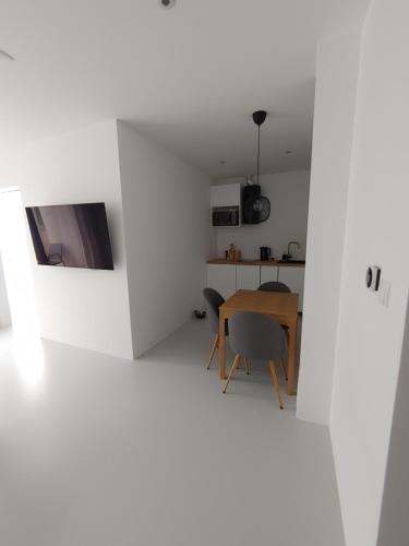 a room with white walls and a table and chairs at Apartamenty HELIOS in Jastrzębia Góra