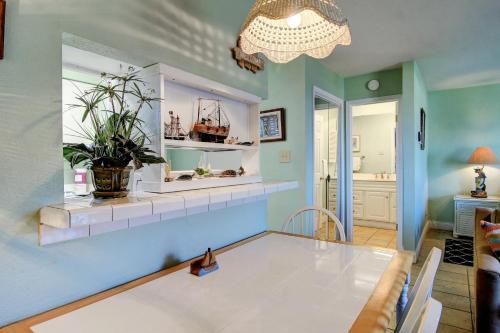 a dining room with a display case with a boat on it at Bay Tree B5 in Port Aransas