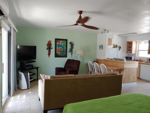 a living room with a couch and a ceiling fan at Bay Tree B5 in Port Aransas