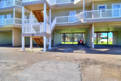 a large apartment building with a staircase in a parking lot at Bay Tree B5 in Port Aransas