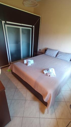 a large bed in a room with a large window at KALLIOPI'S HOUSE in Zilotí