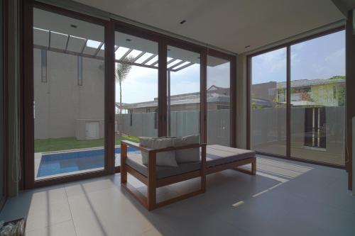 a room with glass windows and a chair in it at Araya Beach Casas in Batangas City