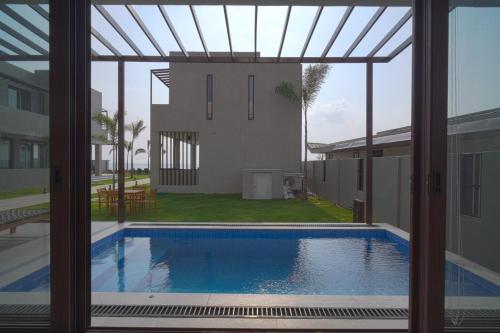 a view of a swimming pool through a window at Araya Beach Casas in Batangas City