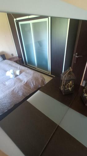 a bedroom with a bed with a window and a table at KALLIOPI'S HOUSE in Zilotí