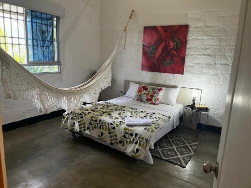 a bedroom with a bed with a blanket on it at Hermosa cabaña amoblada en Pueblo Bello, Sierra Nevada in Pueblo Bello