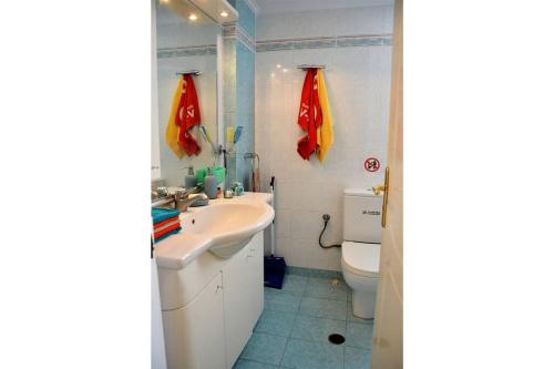 a bathroom with a sink and a toilet at Blue View of Korinthian bay villa in Lecheo in Lékhaion