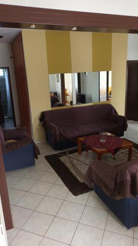 a living room with a couch and a table at KALLIOPI'S HOUSE in Zilotí