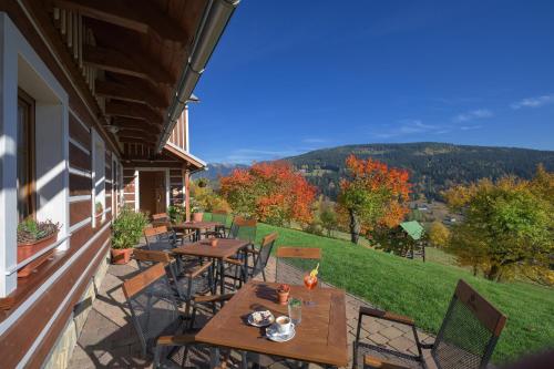 a patio with tables and chairs on a house at U Novotných in Špindlerův Mlýn