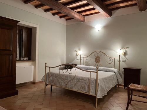 a bedroom with a bed and two lights on the wall at Agriturismo Le Sorgenti in Norcia